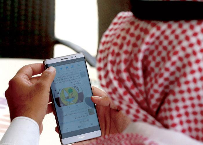 a Saudi man explores social media on his mobile device in Riyadh, Saudi Arabia