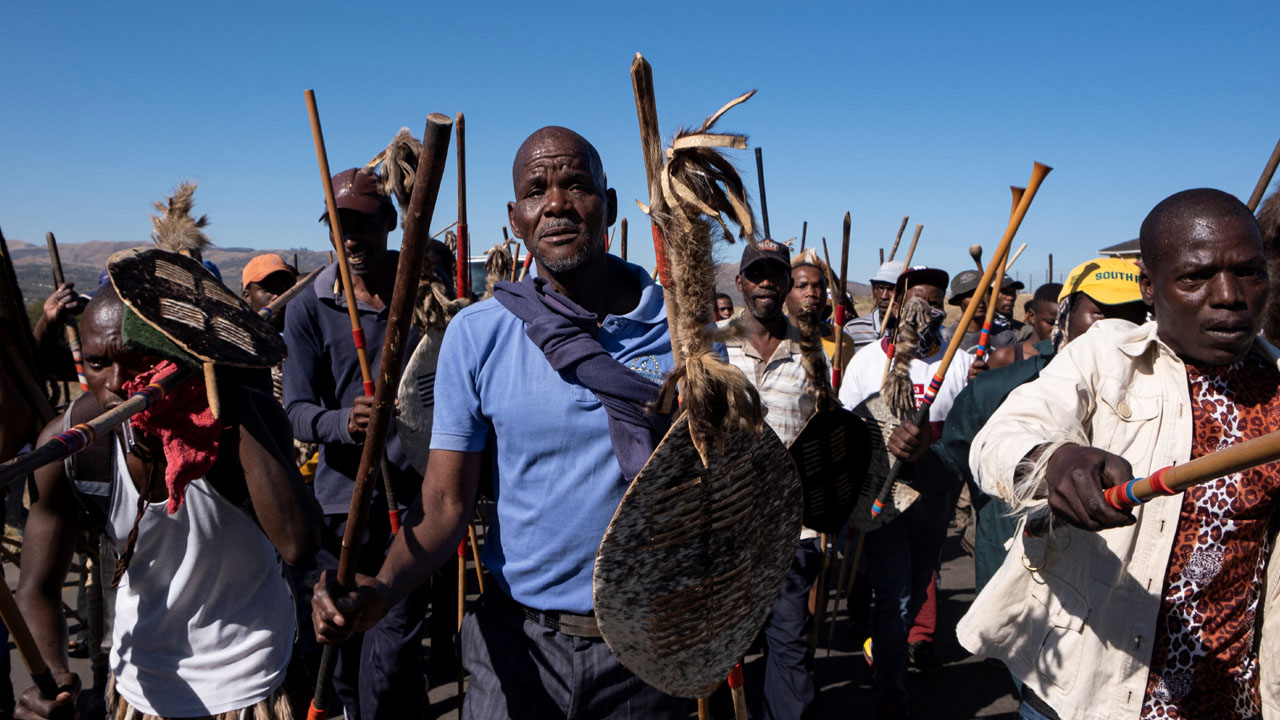 Supporters march in the street outside former South African president Jacob Zuma’s rural home in Nkandla on