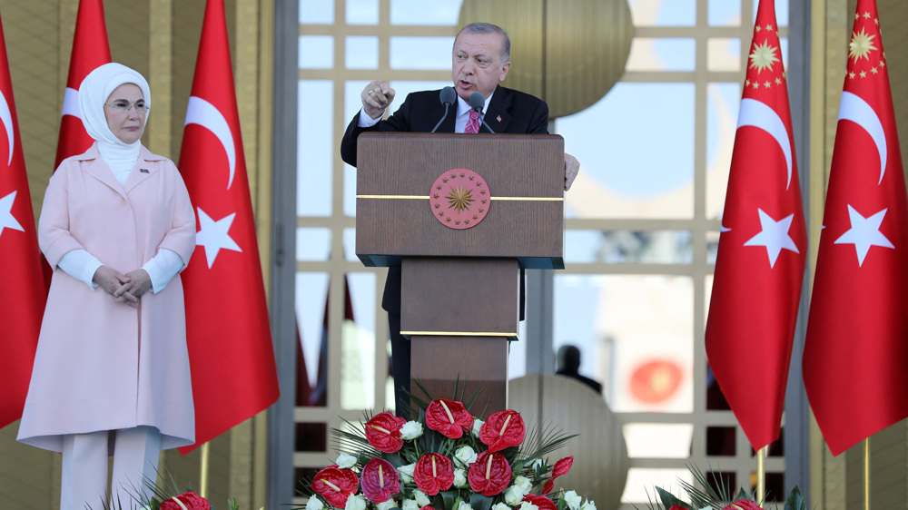 Erdogan gives a speech next to his wife Emine Erdogan during a ceremony at the Complex in Ankara, Turke