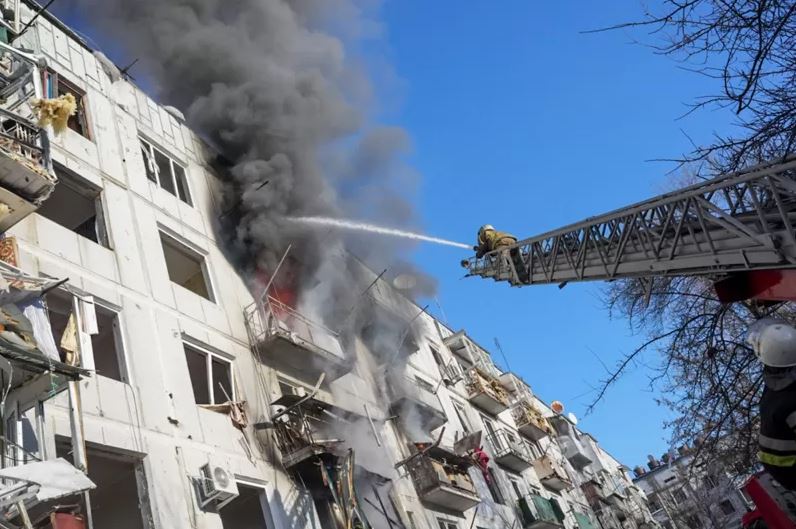 An apartment in Chuhuiv, Kharkiv, Ukraine, became the target of an airstrike and caught fire. Firefighters trying to put out the fire