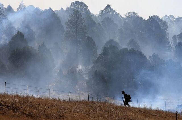 New Mexico firefighters beg residents to evacuate as wildfires char villages