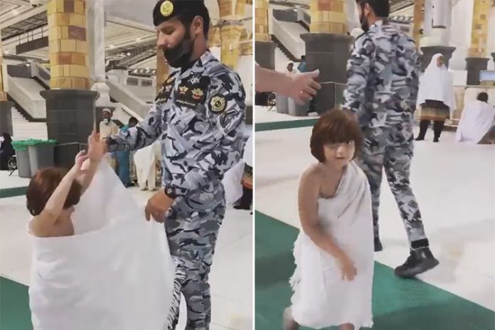 Saudi: Soldier helps a child wear the Ihram in the Grand Mosque of Makkah