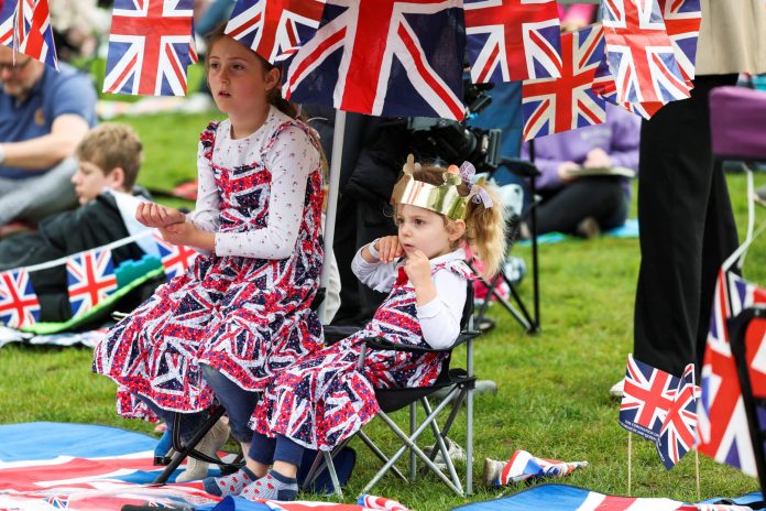 King Charles’ coronation draws thousands in paper crowns and plastic tiaras