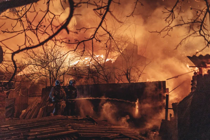 Emergency service workers extinguish a fire after shelling on the Bakhmut frontline in Ivanivske